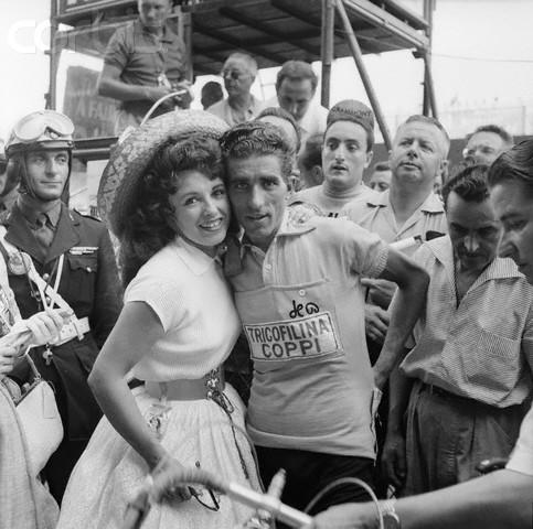 between June 25 and July 18, 1959, Paris, France --- Popular accordionist Yvette Horner poses with Federico Bahamontes of the Spanish Bicycling Team after the 46th Tour de France in 1959. Bahamontes won the yellow jersey as the overall winner of the 1959 Tour, which ran between Mulhouse and Paris. --- Image by © Universal/TempSport/Corbis